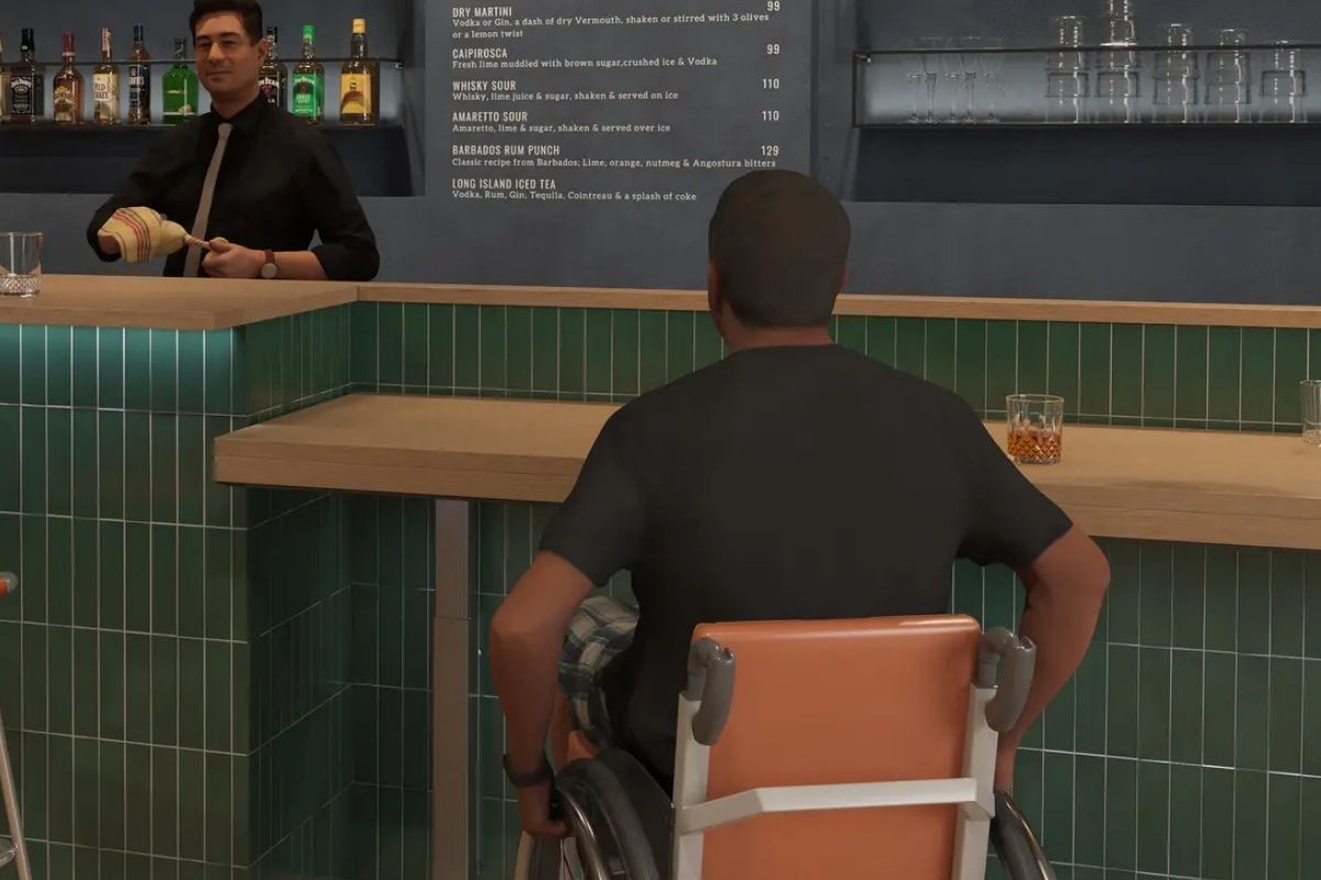 Wheelchair user sits at customized bar counter. 
